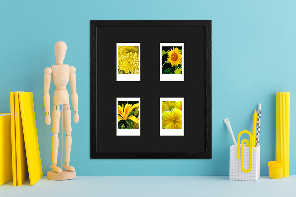 schwarzer Instax Mini Rahmen für vier Bilder modern dekorierter Schreibtisch mit Fotorahmen in Schwarz