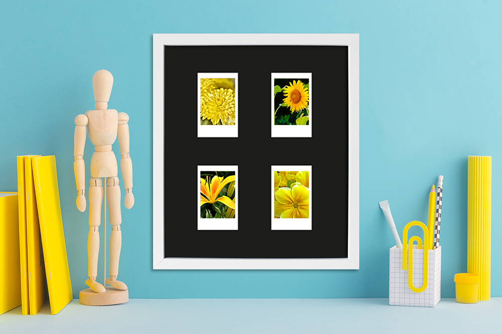 weißer Instax Mini Rahmen für vier Bilder modern dekorierter Schreibtisch mit Fotorahmen in Weiß